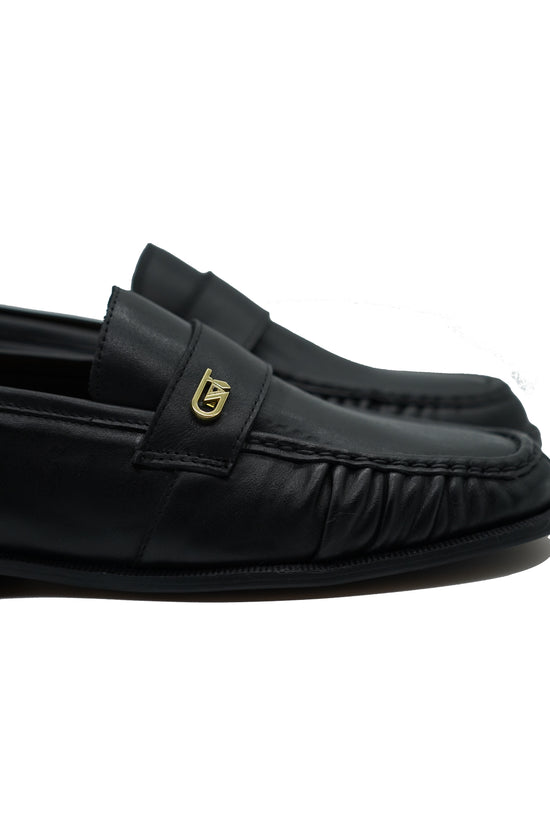 Mocassino tubolare in pelle sauvage nera con arriccio e fibbia GT in metallo oro