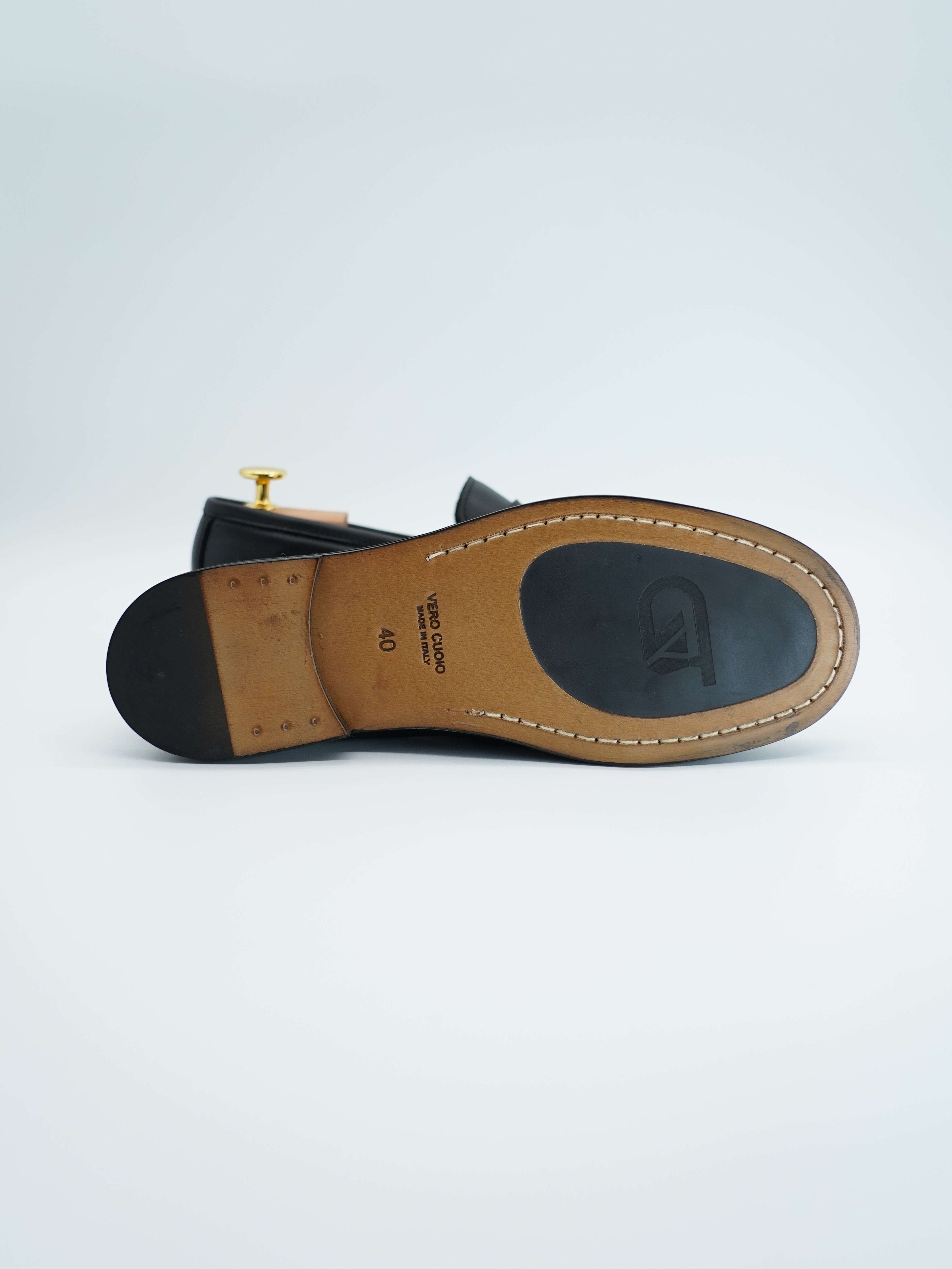 Mocassino tubolare in pelle sauvage nera con arriccio e fibbia GT in metallo oro